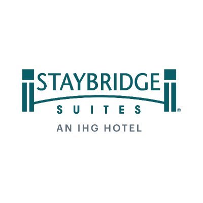 Staybridge Suites logo with the text "STAYBRIDGE SUITES AN IHG HOTEL" in dark teal on a white background.