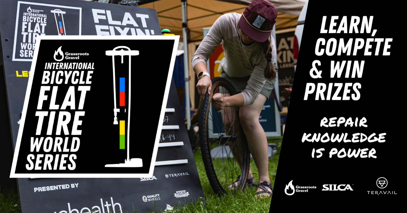 A person fixes a bicycle tire at a tent event for the International Bicycle Flat Tire World Series.